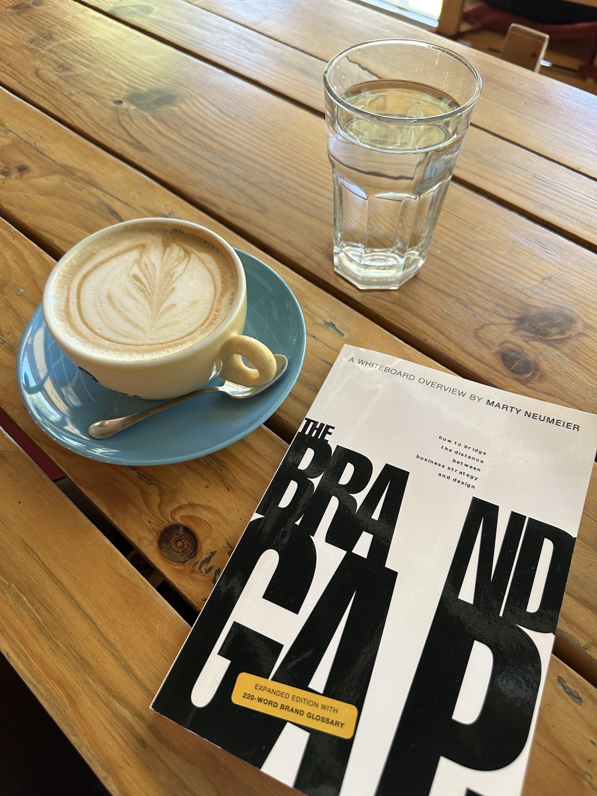 The Brand Gap on a cafe table next to a coffee