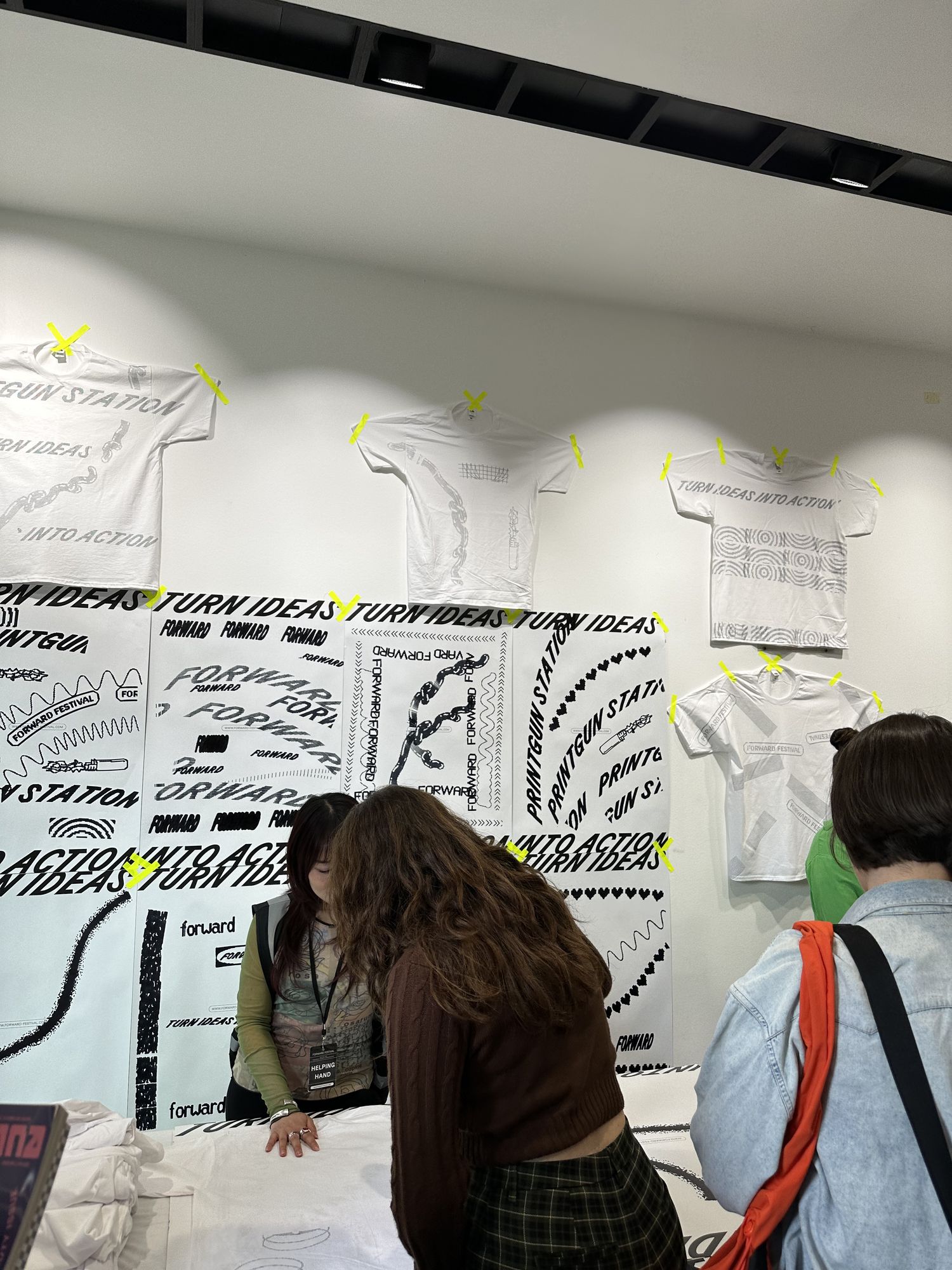 The print station — ideas taped to the wall, still wet.