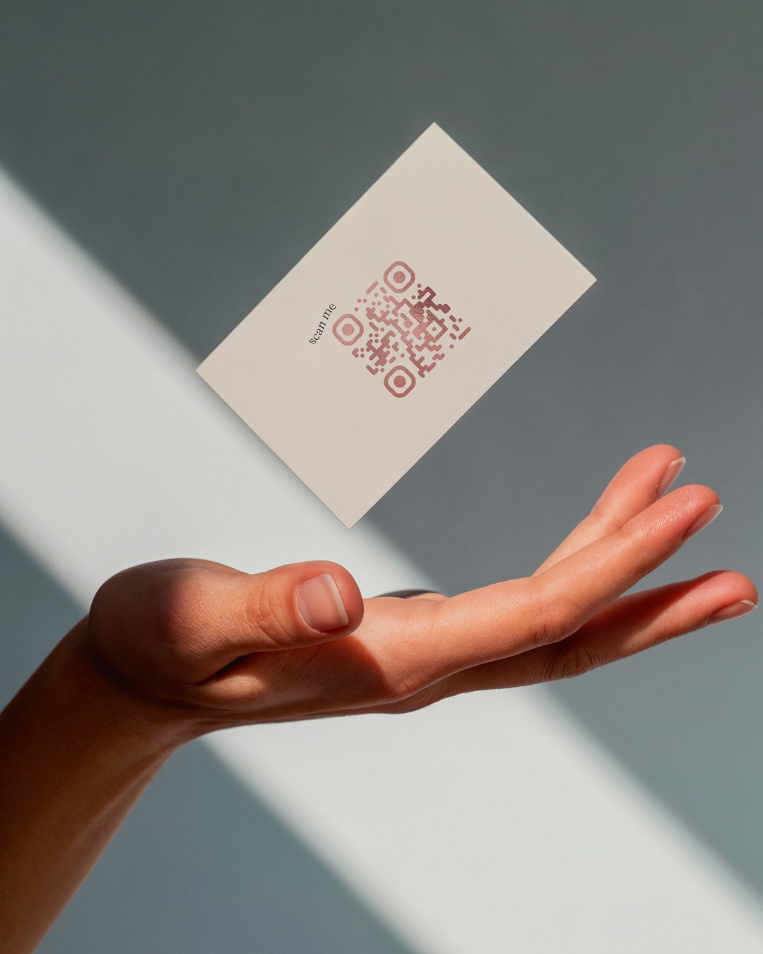 The back of the same card — nothing on it but "scan me" and the QR code in rose foil.